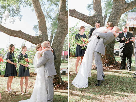 Bride and groom share kiss at outdoor wedding ceremony