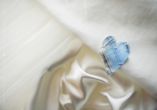 Blue heart made of fabric on white textured background