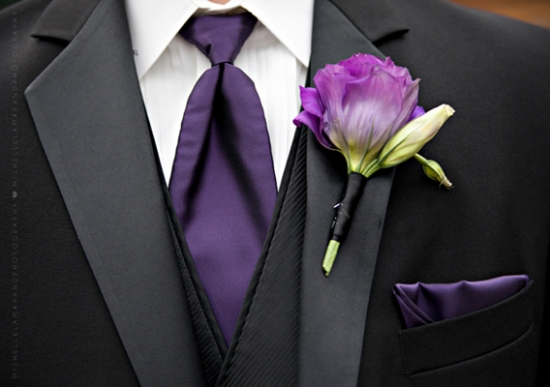 Elegant black tuxedo with purple tie and flower boutonniere