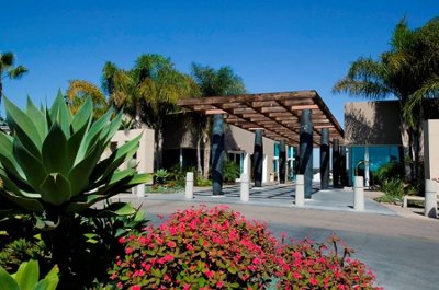 Modern building entrance with lush landscaping