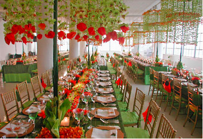 Elegant wedding reception with red and green floral decorations