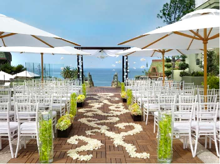 Wedding ceremony set up with ocean view and parasols