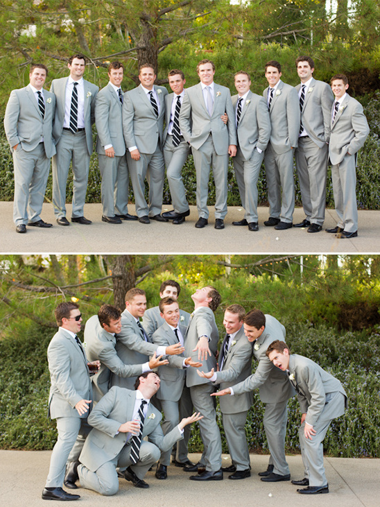 Groomsmen in grey suits posing for a fun and silly wedding photo