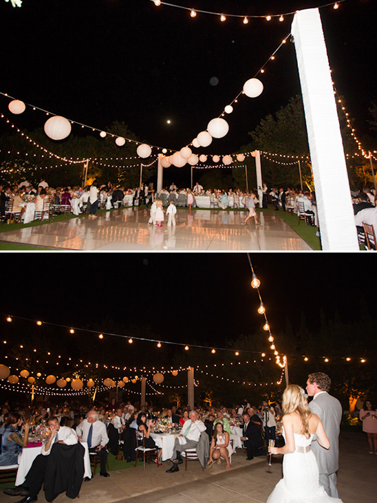 Wedding reception under string lights and paper lanterns at night