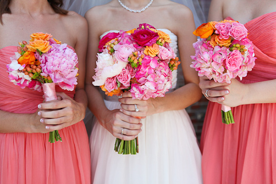 Coral bridesmaid bouquets with pink and orange flowers