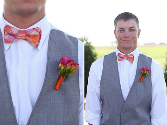 Groom in grey vest, orange bow tie, floral boutonniere