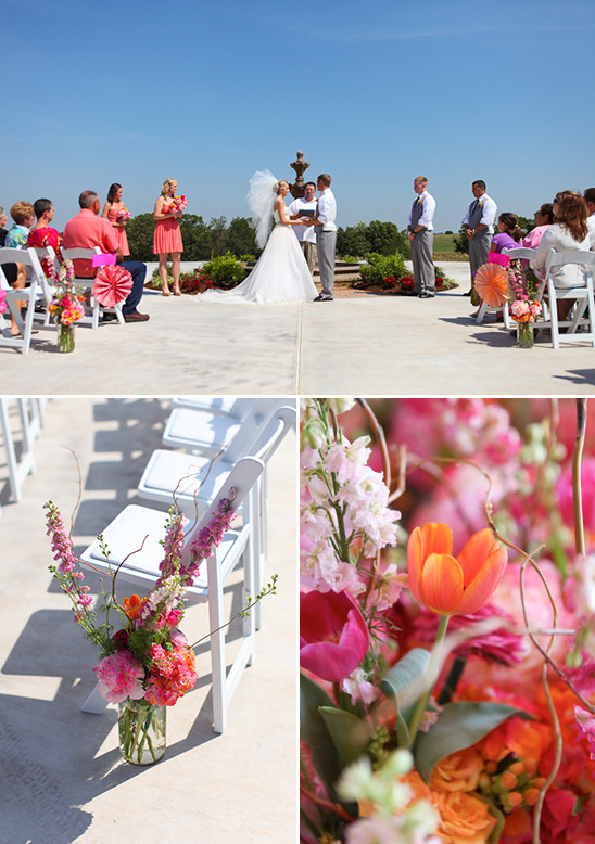 Outdoor wedding ceremony with coral flowers and white chairs