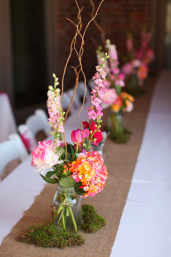 Colorful floral arrangement in a jar on a table runner