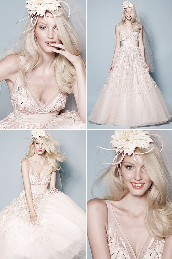 Blonde bride in a stunning blush wedding dress poses gracefully