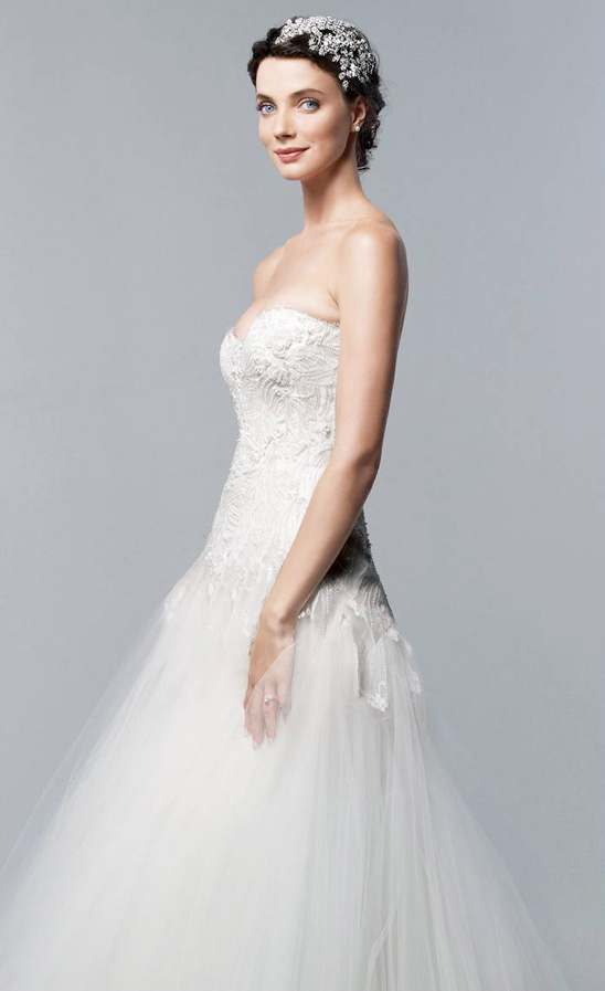 Beautiful bride in a strapless wedding gown smiling gently