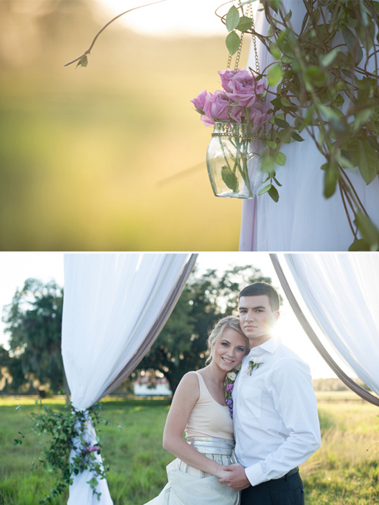 Romantic wedding decor with couple and hanging flowers