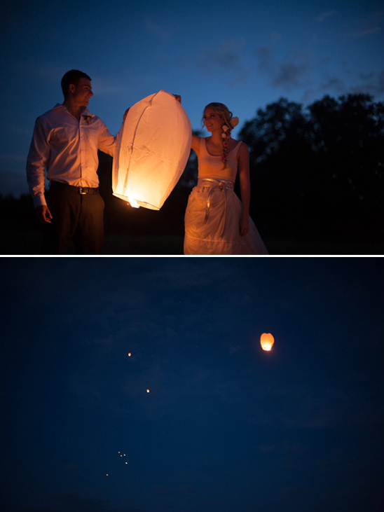 Couple releasing a sky lantern at night, lanterns floating in the sky