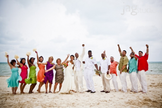 Joyful wedding party celebrating on a beach