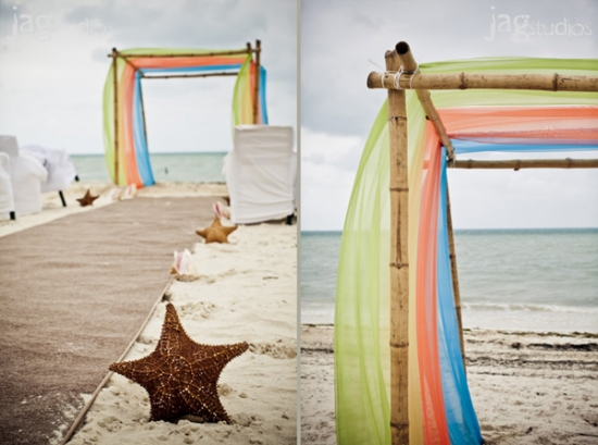 Beach wedding ceremony with colorful fabric and starfish