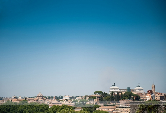 Wedding photo with clear blue sky, overlooking a city