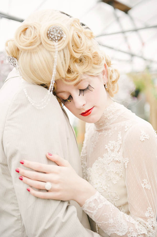 Bride in vintage dress with dramatic makeup hugs groom