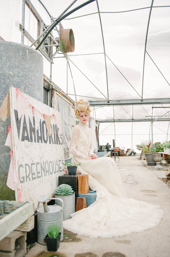 Bride in gown sits in vintage Vanhoriks greenhouse