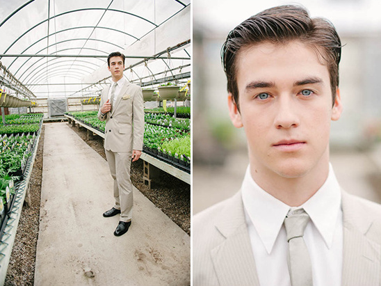 Handsome man in suit poses in greenhouse setting