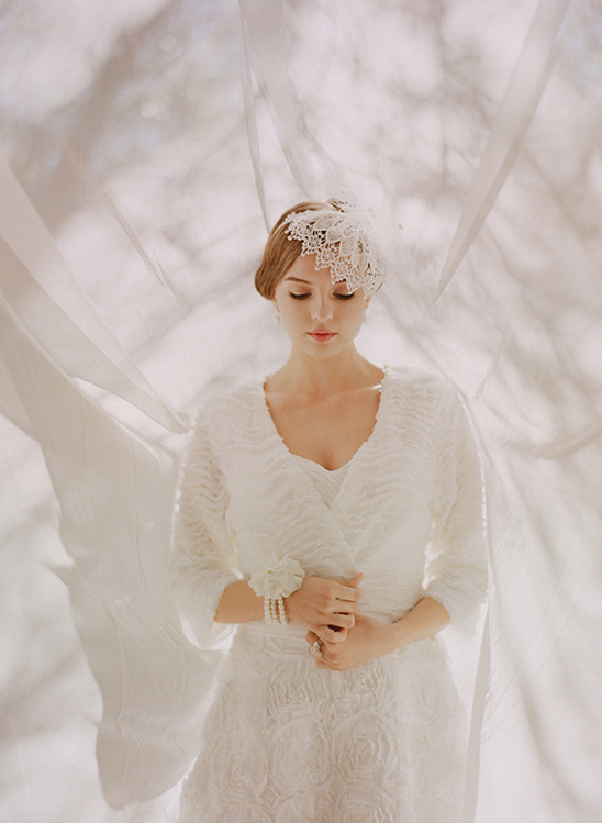 Woman in white wedding dress with lace headpiece