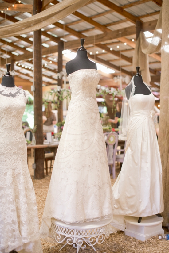 Gorgeous wedding dresses on display in rustic barn