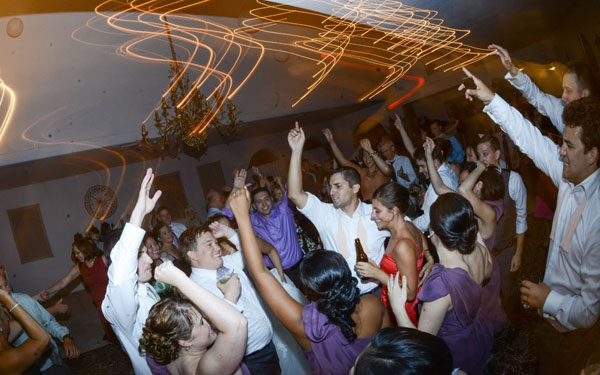 Wedding reception partygoers dancing joyfully indoors