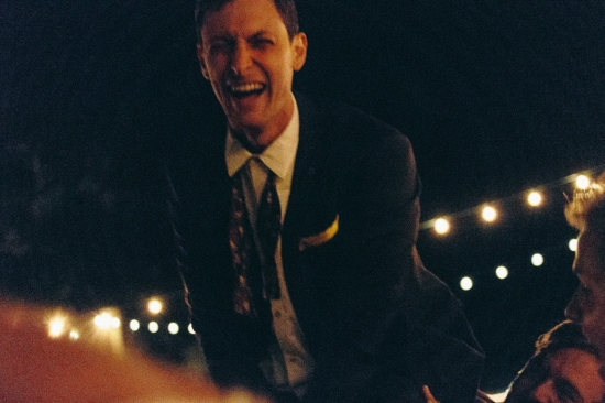 Man laughing outdoor party night