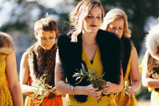 Women in yellow dresses with fur shawls