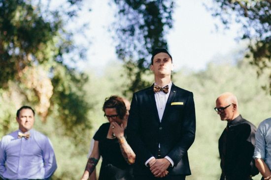 Groom and guests at outdoor wedding