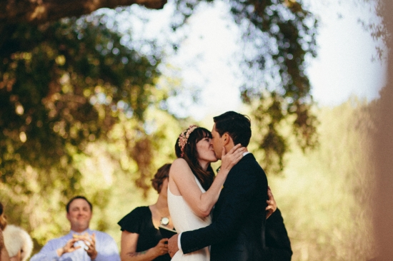 Couple kissing outdoors at wedding