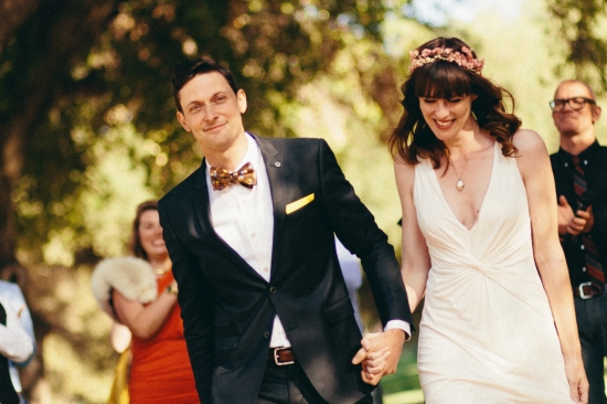 Couple walking hand in hand at wedding