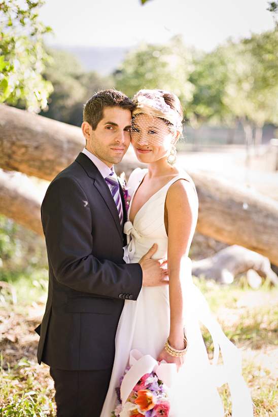 Couple in wedding attire outdoors
