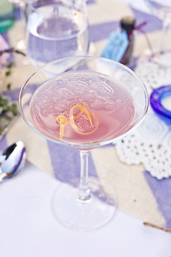 Pretty pink cocktail garnished with lemon