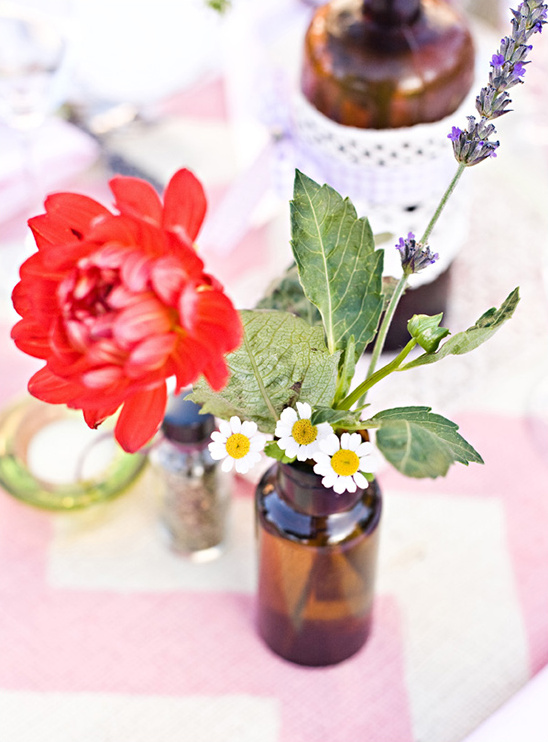 Table setting with red dahlia and daisy flower arrangement