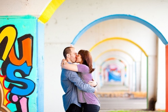 Couple kissing under colorful arches