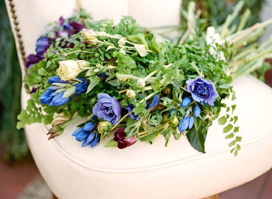 Blue and purple flower bouquet on white chair closeup
