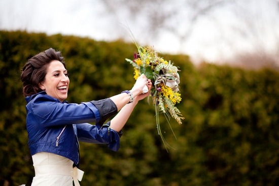 Bride joyfully tosses vibrant wedding bouquet