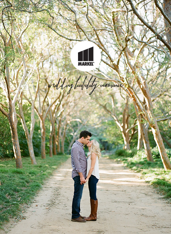 Couple kissing on path, Markel wedding liability insurance