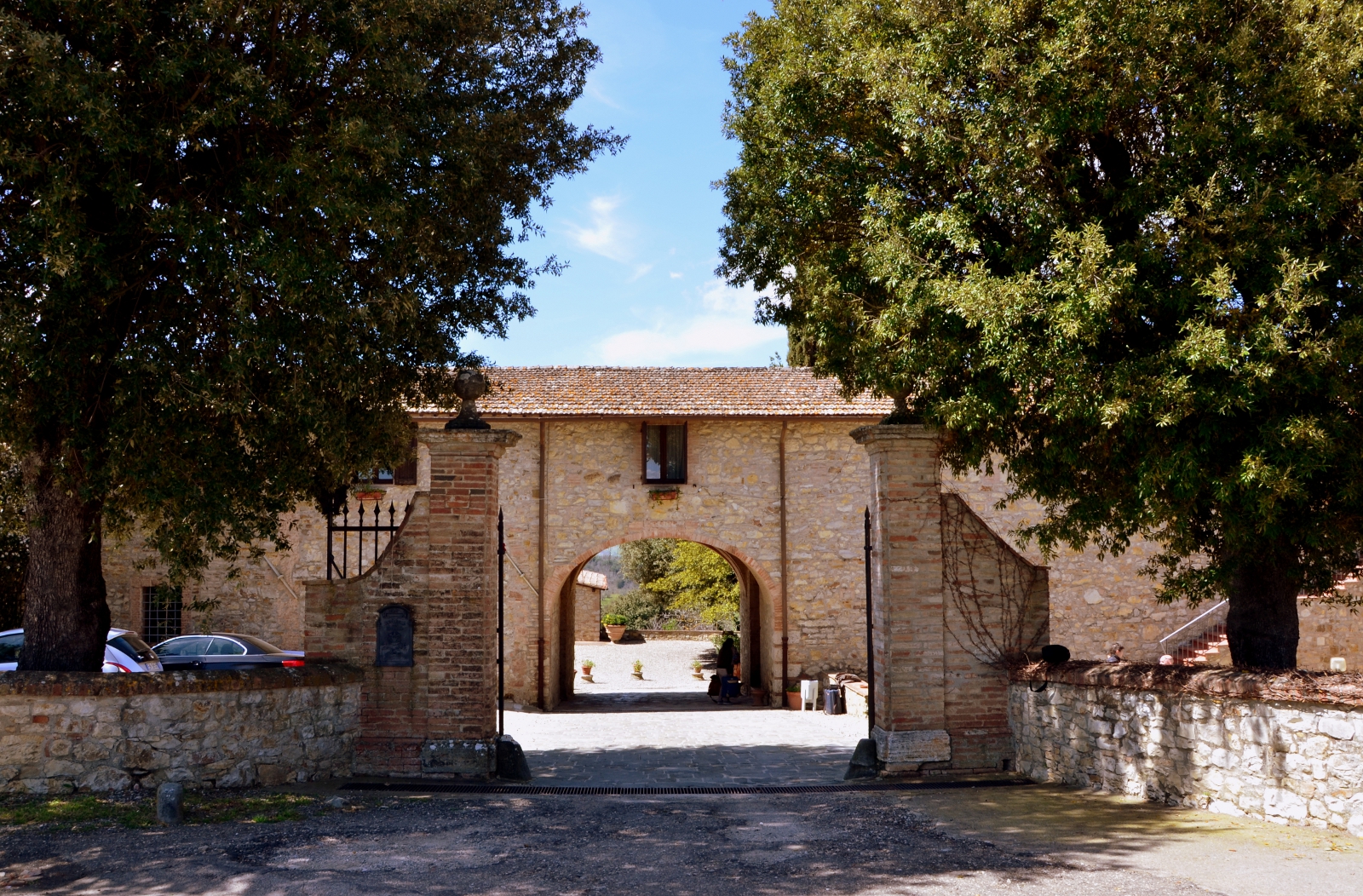 Stone gatehouse entrance to a rural Italian villa estate