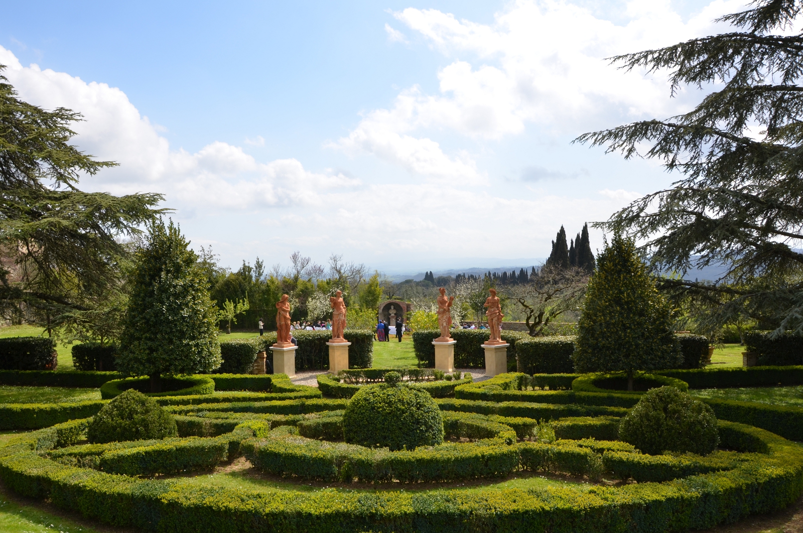 Formal garden with statues and Tuscan landscape view