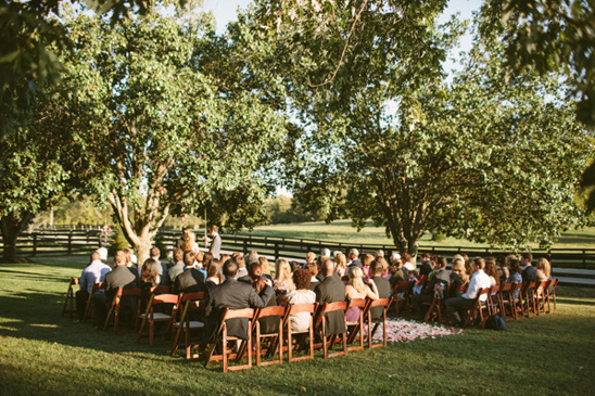 Outdoor wedding ceremony with guests seated on lawn
