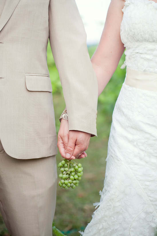 Couple holding hands wedding grapes