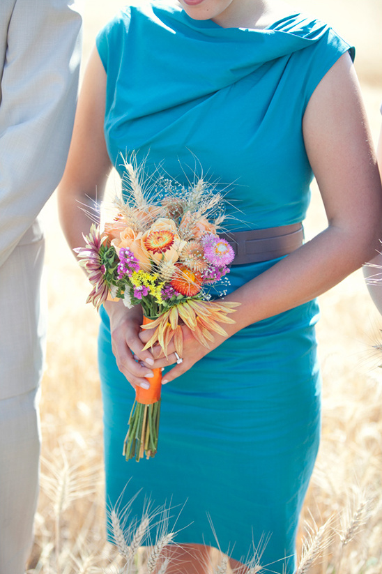 Teal bridesmaid dress with colorful flower bouquet