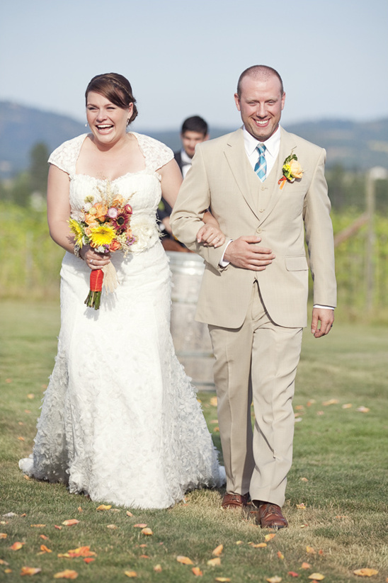 Newlyweds beaming on their wedding day at vineyard