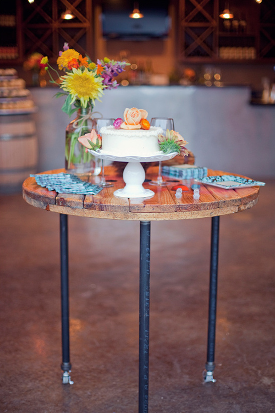 Wedding cake flowers and rustic wood table decor