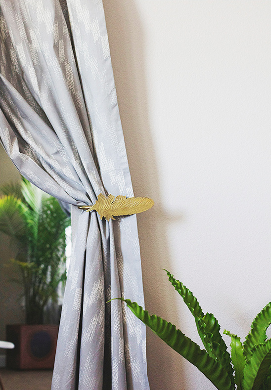 Gray curtain with gold feather tie back detail