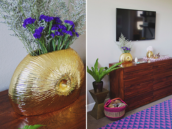 Golden nautilus vase with purple flowers and home decor