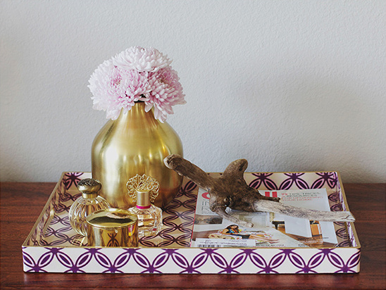 Tray with flowers perfume and magazine still life decor