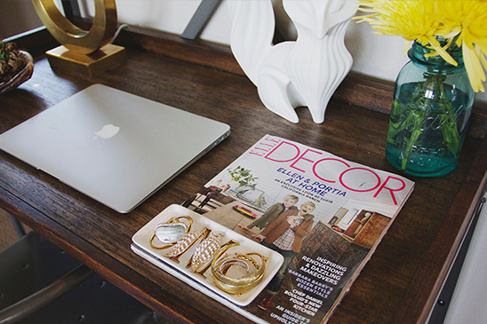 Desk scene with laptop decor magazine and fox figurine