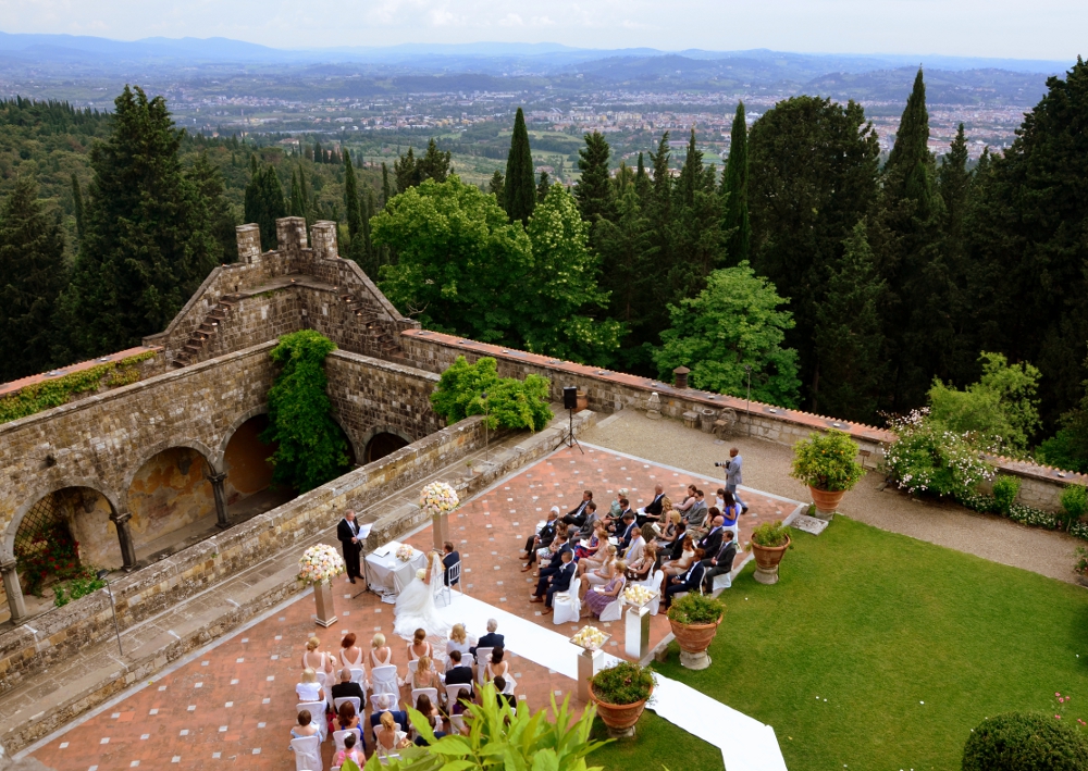 Outdoor wedding ceremony at Italian castle courtyard