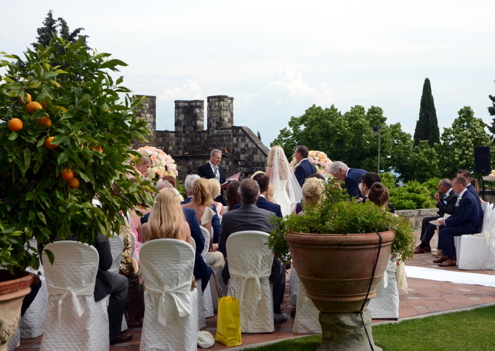 Outdoor wedding ceremony with castle backdrop